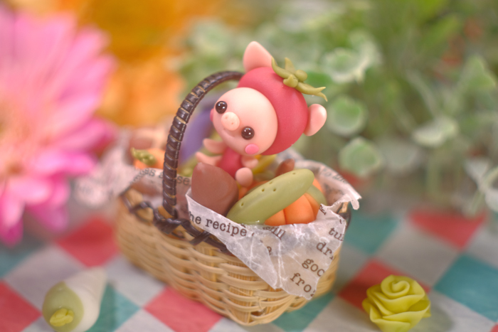 ツバキアキラが撮ったブタちゃんの写真。お野菜のカゴの中で楽しそうな可愛いブタちゃんです。